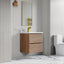 Bathroom with wooden vanity, mirror, and toilet.