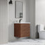 Bathroom with wooden vanity, mirror, and toilet.
