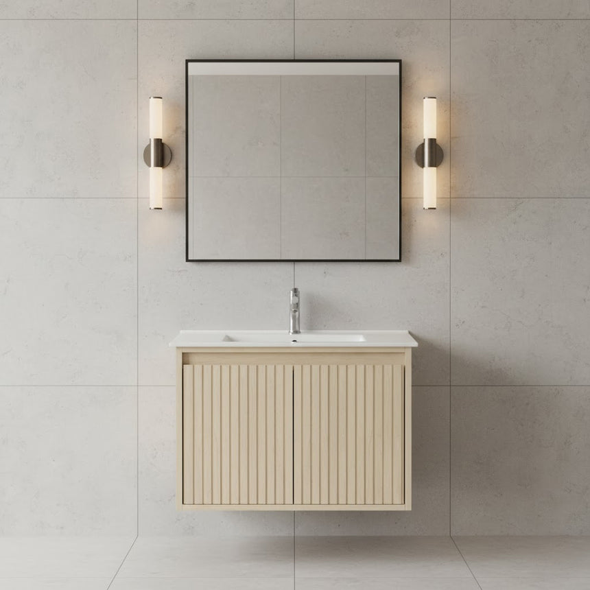 Bathroom vanity with mirror and lighting fixtures on a tiled wall.