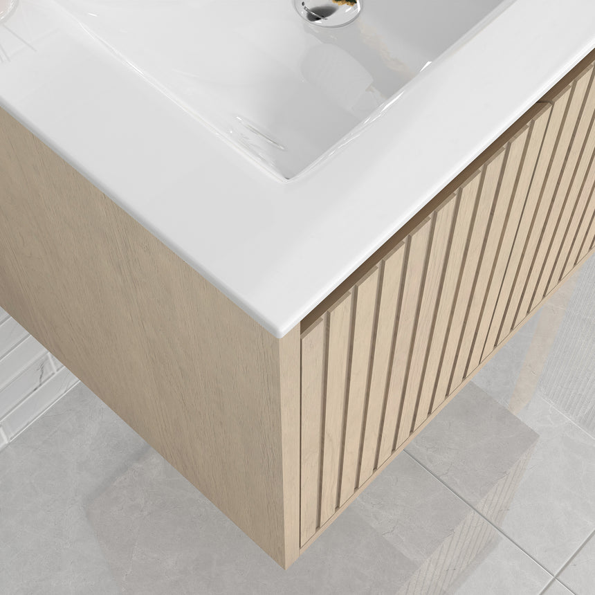 Bathroom vanity with mirror and lighting fixtures on a tiled wall.