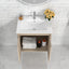 Bathroom vanity with sink, mirror, and decorative items on a tiled wall.