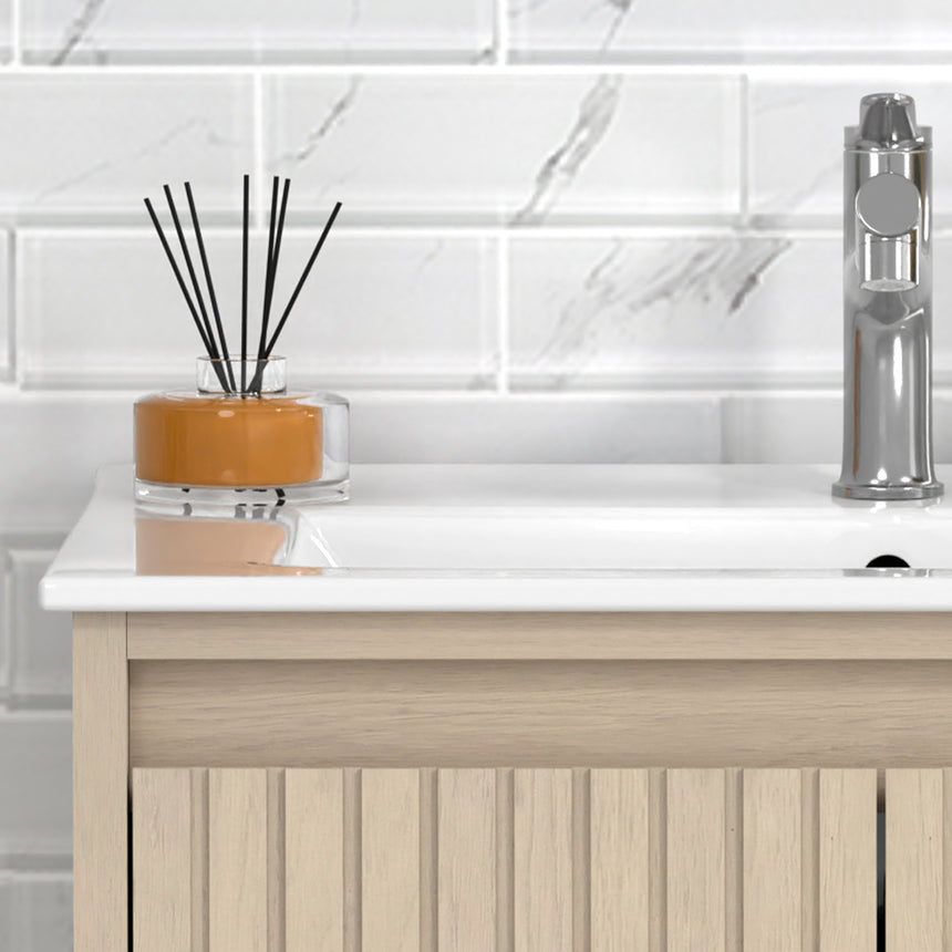 Bathroom vanity with mirror and lighting fixtures on a tiled wall.