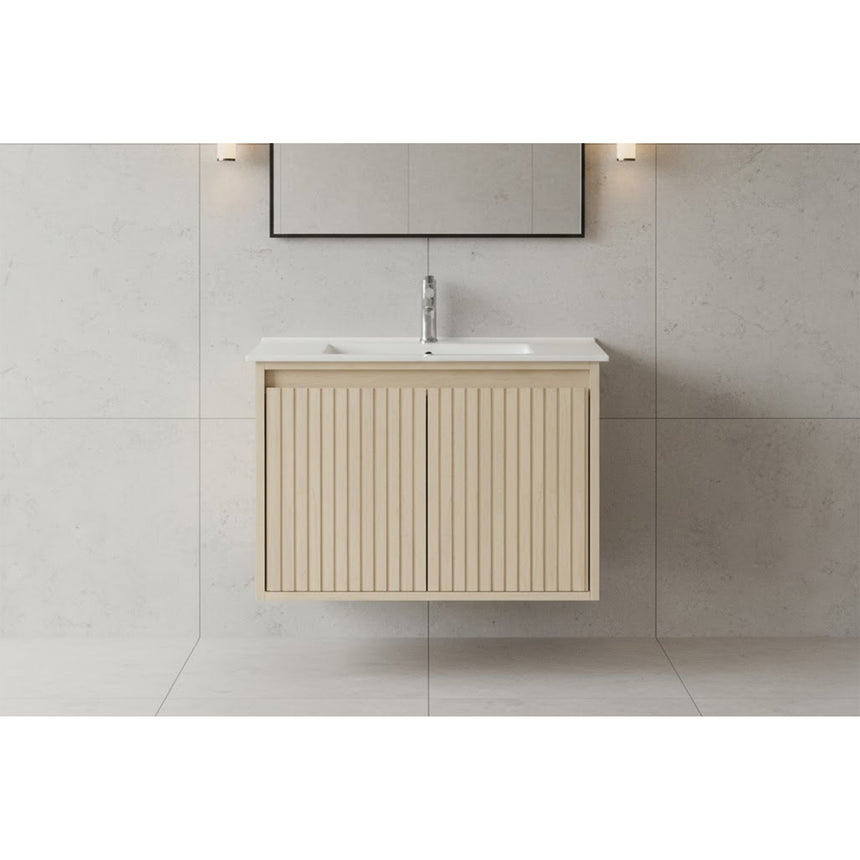 Bathroom vanity with mirror and lighting fixtures on a tiled wall.