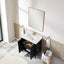 Bathroom vanity with white sink, black cabinet, and gold fixtures.