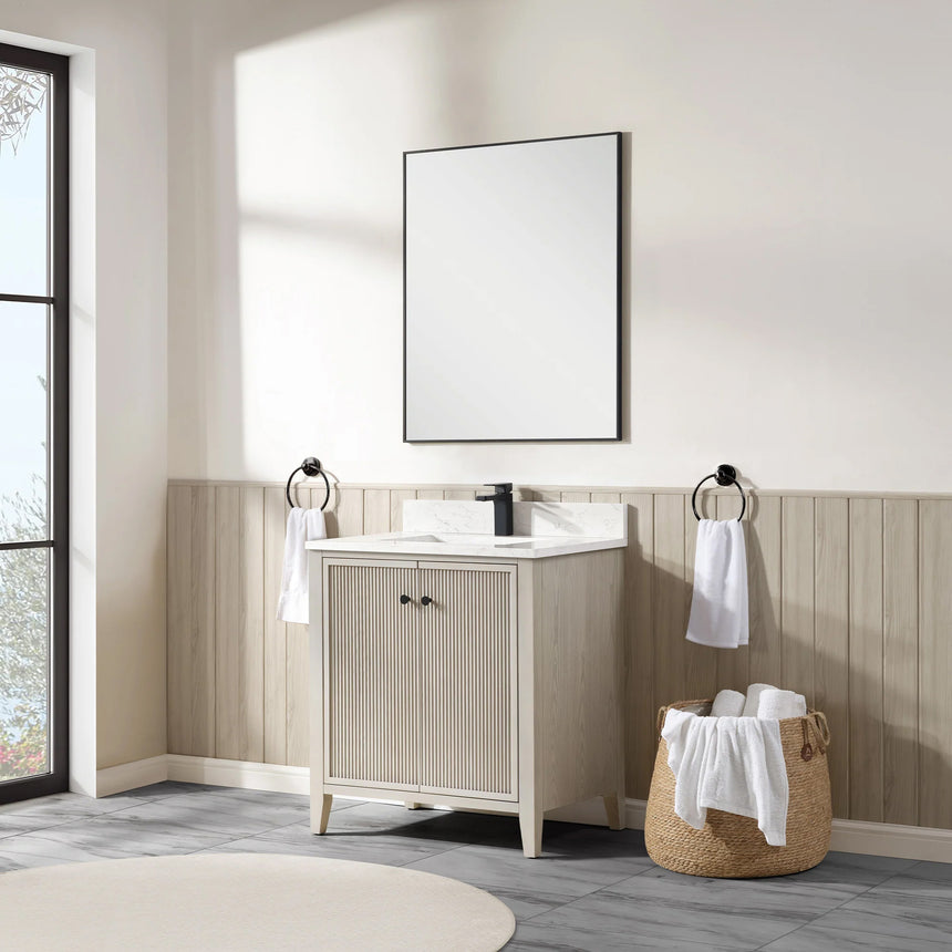 Bathroom vanity with double sink, mirrors, and towels in a well-lit room.