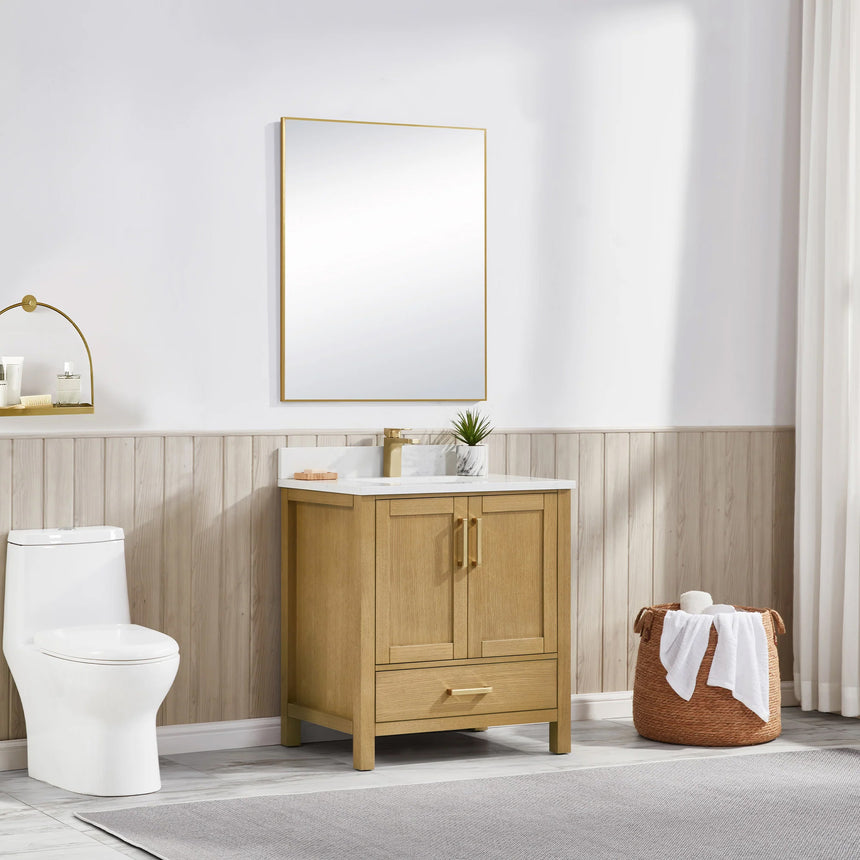 Bathroom vanity with wooden cabinets and white countertop, featuring a toilet and towel on the side.