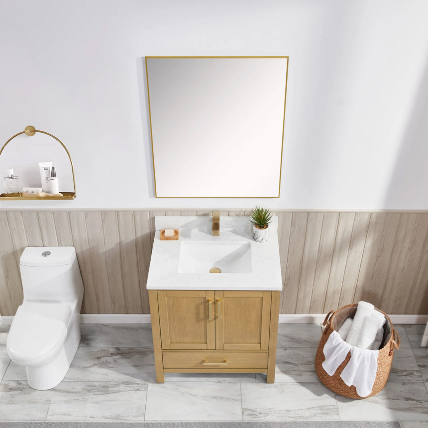 Bathroom vanity with wooden cabinets and white countertop, featuring a toilet and towel on the side.