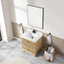 Bathroom with wooden vanity, white sink, and mirror