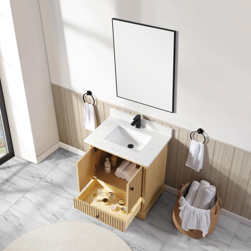 Bathroom vanity with wooden cabinet and white countertop in a bathroom setting.