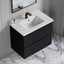 Bathroom vanity with white countertop and black cabinet on a marble floor.