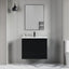 Bathroom setup with a black vanity unit, white sink, and mirror on a gray wall.