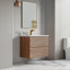 Bathroom with wooden vanity, mirror, and toilet.