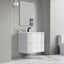 Bathroom with a white vanity unit, mirror, and toilet.