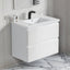 White bathroom vanity with sink and faucet in a modern bathroom setting.