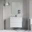 Bathroom vanity with mirror and sink against a gray wall.