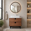Bathroom vanity with wooden cabinet, round mirror, and white sink.