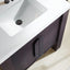 Close-up of a bathroom vanity with a white sink and dark wood cabinet.