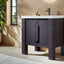 Modern bathroom vanity with a white countertop and black cabinet in a well-lit room.