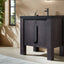 Modern black bathroom vanity with sink and faucet in a well-lit room.