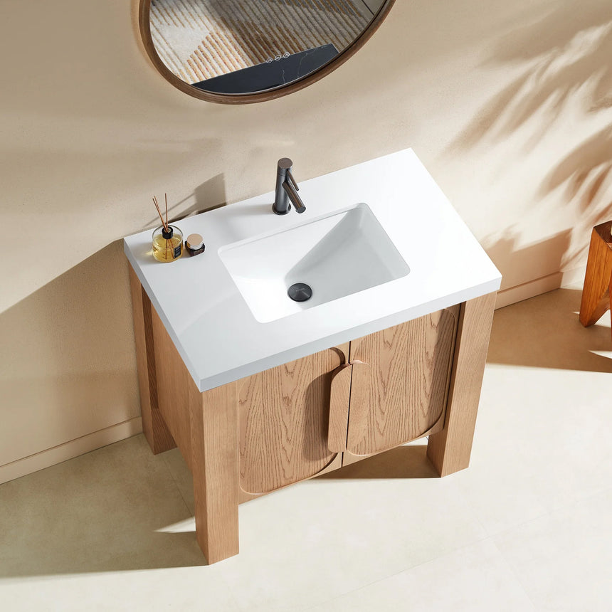 Bathroom with wooden vanity, white countertop, and decorative elements.