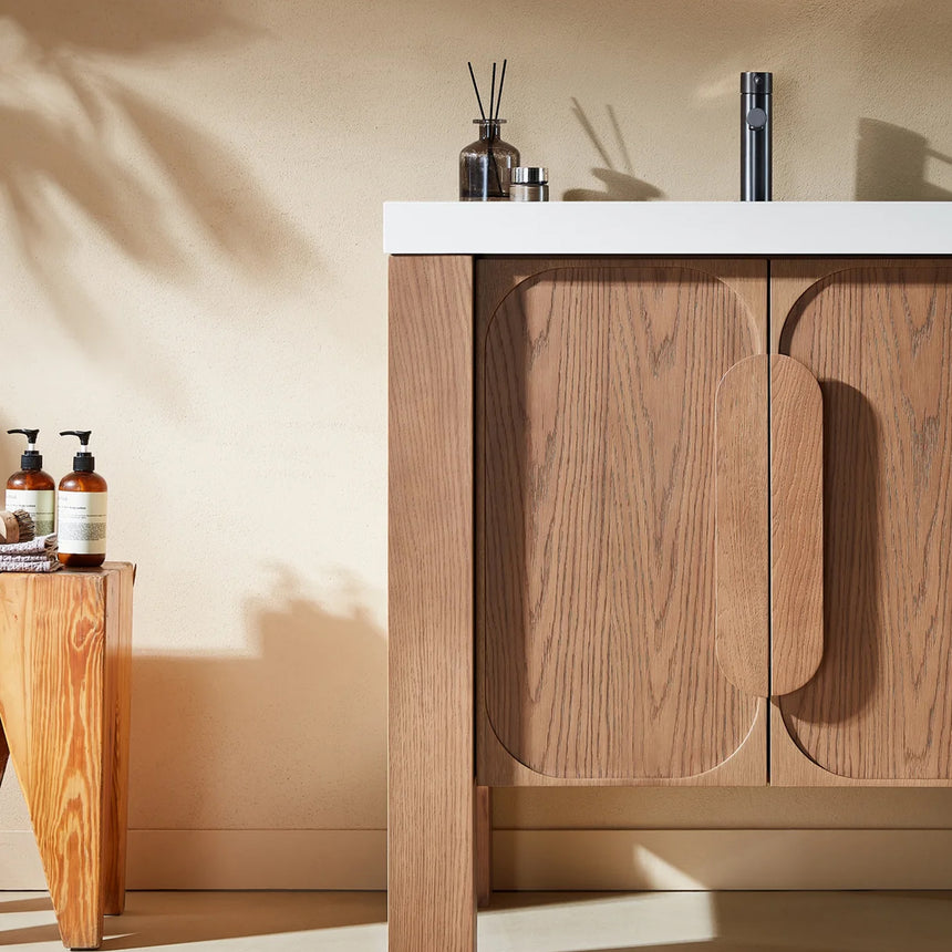 Bathroom with wooden vanity, white countertop, and decorative elements.