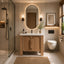 Modern bathroom with wooden vanity, oval mirror, and shower area.