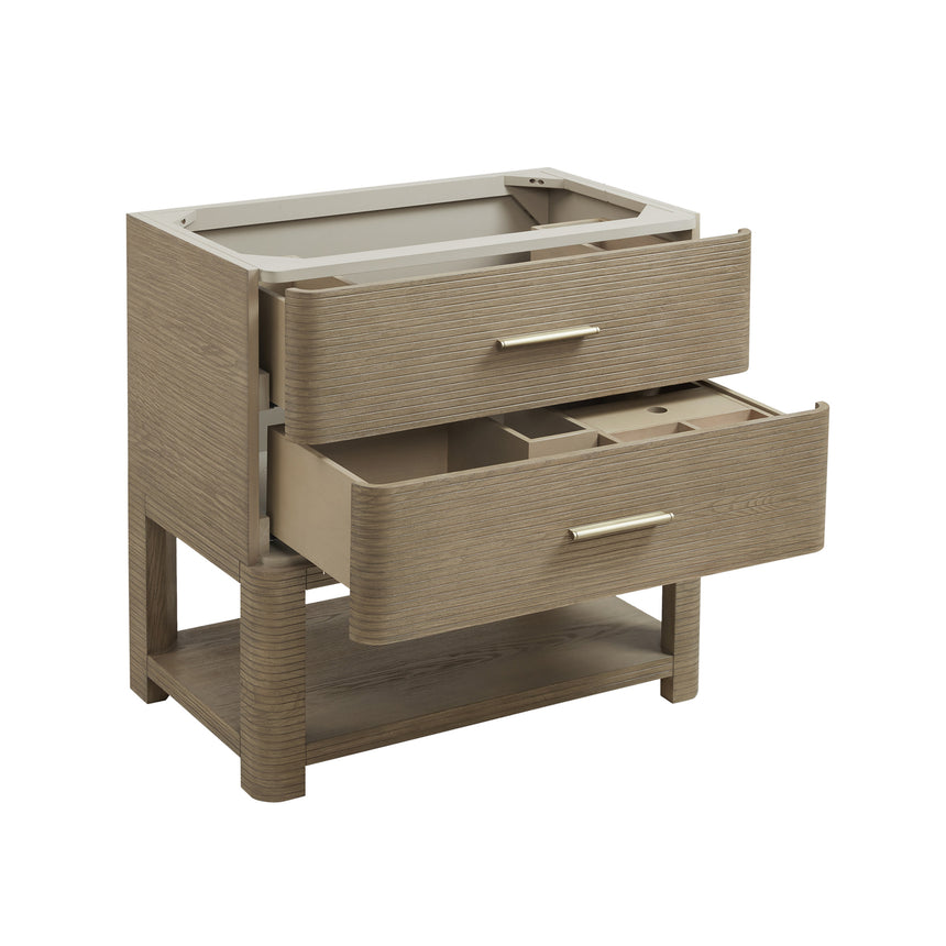 A modern bathroom vanity with a light oak wood frame, six drawers, an open lower shelf, and a white marble top with an integrated sink. The vanity is styled in a bright bathroom with a white freestanding tub, a gold faucet, and a glass shower stall in the background.