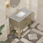 Bathroom vanity with marble countertop and gold fixtures in a tiled room.