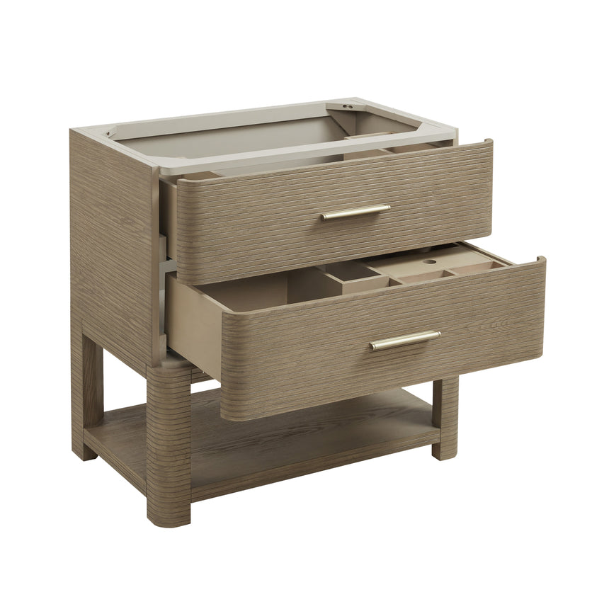 A modern bathroom vanity with a light oak wood frame, six drawers, an open lower shelf, and a white marble top with an integrated sink. The vanity is styled in a bright bathroom with a white freestanding tub, a gold faucet, and a glass shower stall in the background.
