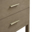 Wooden drawer with gold handles on a neutral background, close-up