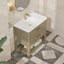 Bathroom vanity with white sink and gold fixtures in a tiled bathroom.