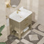 Bathroom vanity with white sink and gold fixtures in a tiled room.