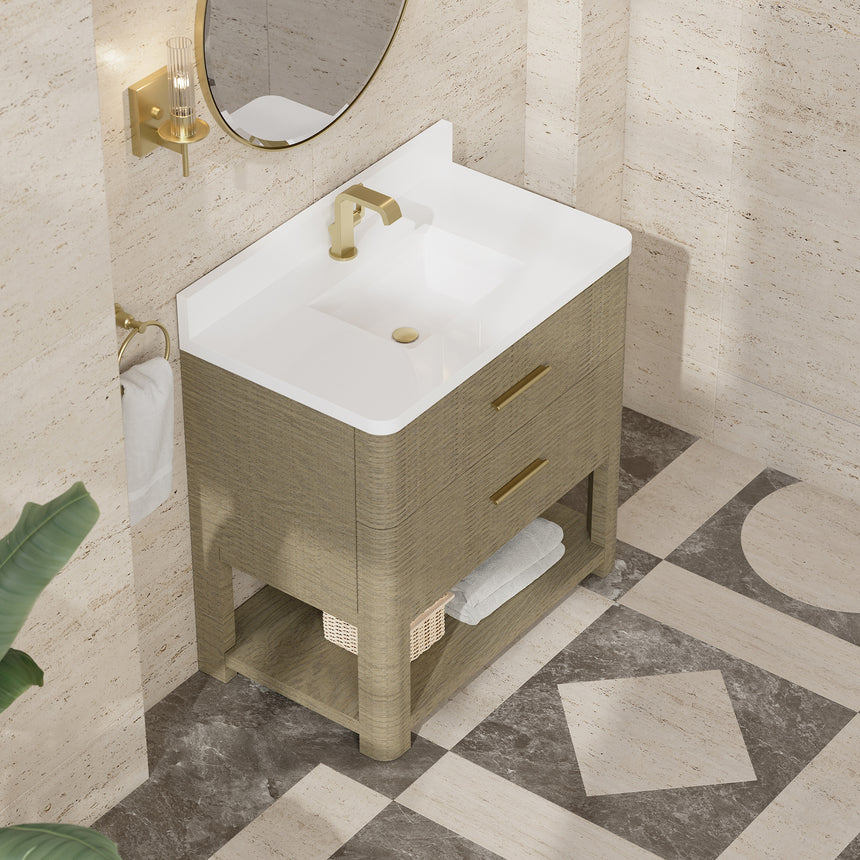 A modern bathroom vanity with a light oak wood frame, six drawers, an open lower shelf, and a white marble top with an integrated sink. The vanity is styled in a bright bathroom with a white freestanding tub, a gold faucet, and a glass shower stall in the background.
