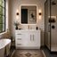 Modern bathroom with white vanity, illuminated mirror, and freestanding bathtub.