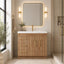Bathroom vanity with wooden cabinet, mirror, and decorative elements.