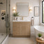 Modern bathroom with wooden vanity, mirror, and bathtub.