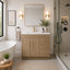 Modern bathroom with wooden vanity, freestanding bathtub, and shower area.