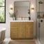 Bathroom with wooden vanity, mirror, and bathtub
