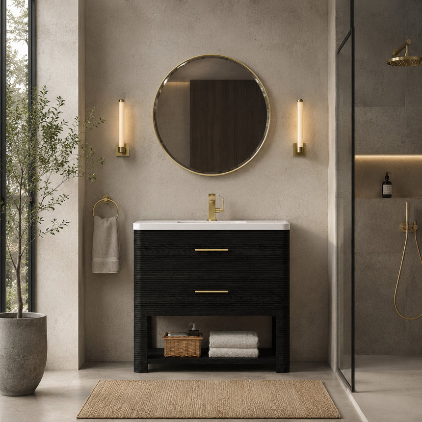 A modern bathroom vanity with a light oak wood frame, six drawers, an open lower shelf, and a white marble top with an integrated sink. The vanity is styled in a bright bathroom with a white freestanding tub, a gold faucet, and a glass shower stall in the background.