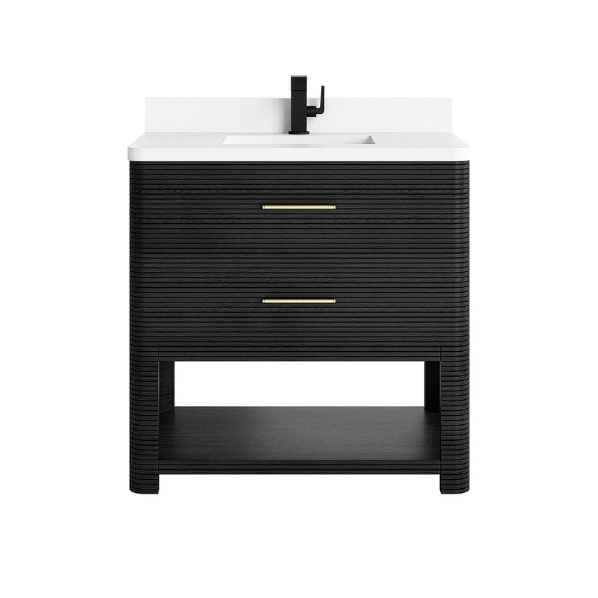 A modern bathroom vanity with a light oak wood frame, six drawers, an open lower shelf, and a white marble top with an integrated sink. The vanity is styled in a bright bathroom with a white freestanding tub, a gold faucet, and a glass shower stall in the background.