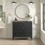 Bathroom with black vanity, round mirror, and decorative elements.