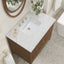 Bathroom vanity with marble countertop, faucet, and decorative elements.