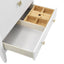 Wooden drawer insert with compartments inside a white cabinet.