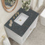 Bathroom vanity with marble countertop and white sink, featuring decorative elements.