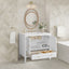 Bathroom vanity with open drawer, round mirror, and decorative elements.