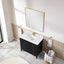 Bathroom vanity with white sink, black cabinet, and gold fixtures.
