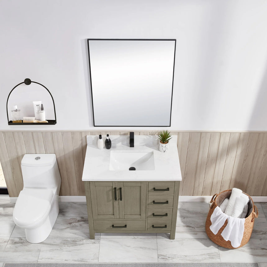 Bathroom vanity with wooden cabinets and white countertop, featuring a toilet and towel on the side.