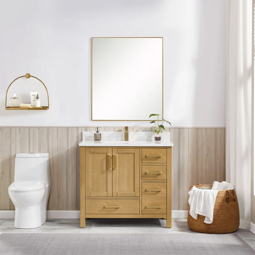 Bathroom vanity with wooden cabinets and white countertop, featuring a toilet and towel on the side.