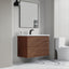 Bathroom with wooden vanity, mirror, and toilet.