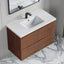 Bathroom vanity with wooden cabinet and white countertop on a marble floor.